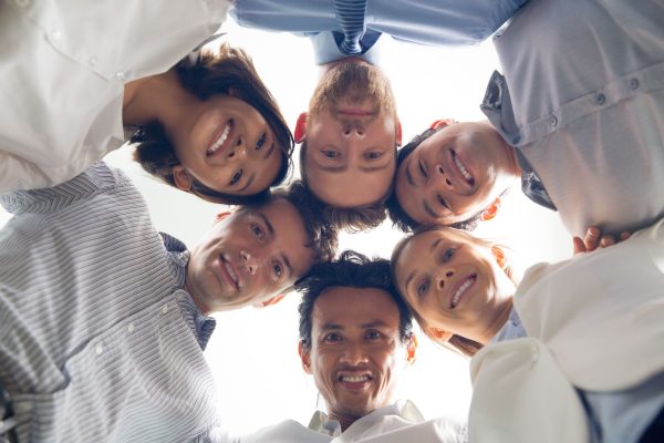 smiling-international-business-team-huddling (1)